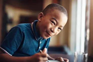 boy in a polo eating spaghetti